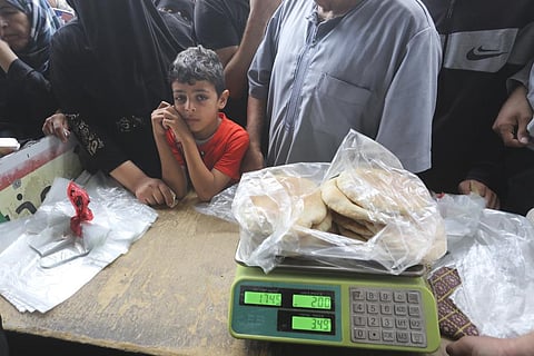 Palestinians wait to buy bread during the ongoing bombardment of the Gaza Strip in Rafah on Sunday, Oct. 29, 2023. (Photo | AP)