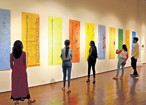 Visitors check out calligraphy exhibits at Durbar Hall Gallery in Kochi