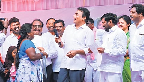 MA&UD Minister KT Rama Rao shares a light moment with a beneficiary while distributing 2BHK sanction letters in Suryapet on Monday.