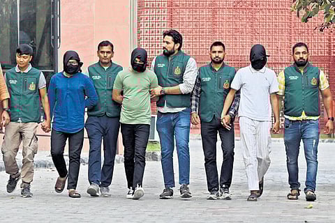 Special Cell sleuths with the 3 terror suspects after arresting them over their alleged links with an ISIS module, in New Delhi on Monday | Parveen Negi