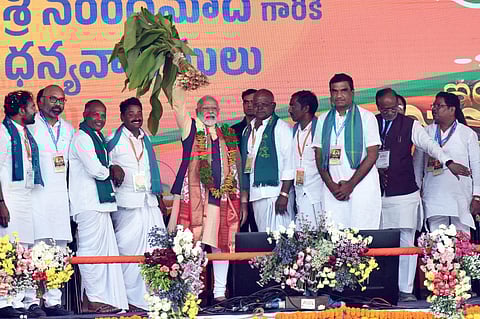 Prime Minister Narendra Modi being felicitated during an event organised for laying of the foundation stone of various developmental projects, in Nizamabad, Telangana. (PTI)