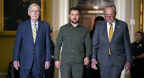 Ukrainian President Volodymyr Zelenskyy, center, walks with Senate Majority Leaders Mitch McConnell, left, and Leader Chuck Schumer, right, at Capitol Hill. (Photo | AP)