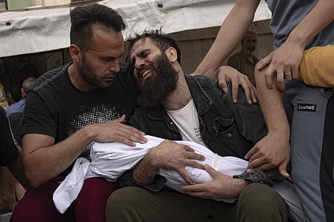 Palestinians mourn their relatives killed in the Israeli bombardment of the Gaza Strip, in a morgue in Khan Younis, Sunday, Oct. 29, 2023. (Photo | AP)