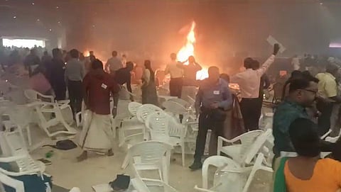 People rush to save themselves after a blast at a convention centre in Kalamassery, in Ernakulam district, Sunday, Oct. 29, 2023.