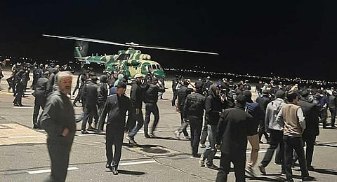 People in the crowd walk shouting antisemitic slogans at an airfield of the airport in Makhachkala, Russia, Monday, Oct. 30, 2023. (AP)