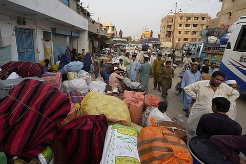 Afghan families wait to board buses to depart for their homeland, in Karachi, Pakistan, Monday, Oct. 30, 2023. (Photo | AP)