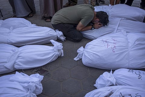 Palestinians mourn relatives killed in the Israeli bombardment of the Gaza Strip, in front of the morgue in Deir al Balah, Tuesday, Oct. 31, 2023. (Photo | AP)