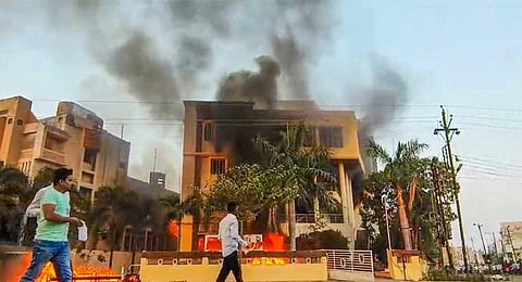 Smoke billows after an office of NCP was set on fire by Maratha reservation agitators, in Beed district, Maharashtra, Monday, Oct. 30, 2023. (PTI)