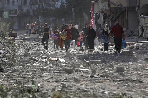 Palestinians seen leaving their homes following Israeli bombardment on Gaza City, on October 30, 2023. (File Photo | AP)