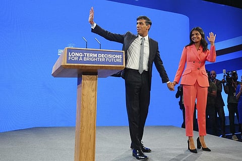 British Prime Minister Rishi Sunak and wife Akshata Murty wave after his speech at the Conservative Party annual conference. (Photo | AP)