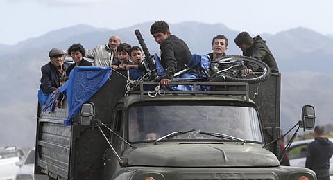 Ethnic Armenians from Nagorno-Karabakh travel on a truck on their way to Kornidzor, Armenia. (Photo | AP)
