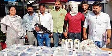 Police officials with the items recovered and arrested members.