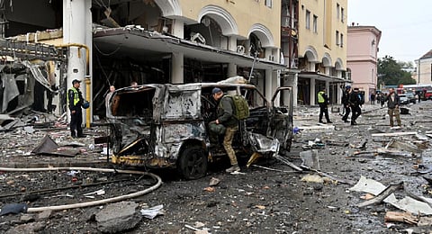 Experts work in an area damaged after a Russian strike to the centre of the Ukrainian city of Kharkiv on October 6, 2023, amid Russian invasion in Ukraine. (Photo | AFP)