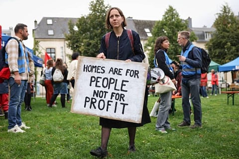 A protestor holds a placard which reads ‘homes are for people not for profit’ during a ‘Faites du Logement’ event organised by the Wunnrech coalition in Luxembourg on September 23, 2023. (Photo | AFP)