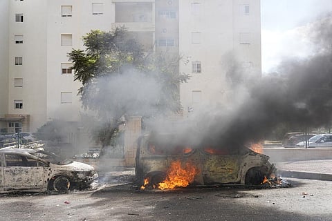 Cars are on fire after they were hit by rockets from the Gaza Strip in Ashkelon, Israel, on Saturday, Oct. 7. (Photo | AP)