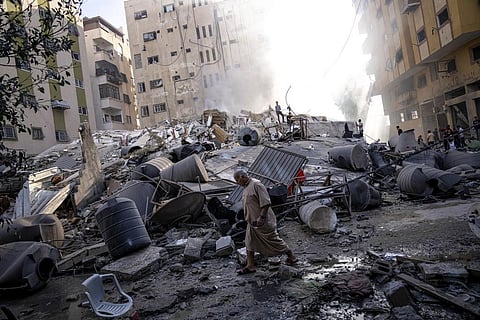 Palestinians inspect the rubble of a building after it was struck by an Israeli airstrike, in Gaza City, Saturday, Oct. 7, 2023. (Photo | AP)