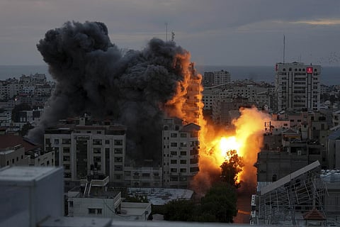 A ball of fire and smoke rise from an explosion on a Palestinian apartment tower following an Israeli air strike in Gaza City, Saturday, Oct. 7, 2023. (Photo | AP)