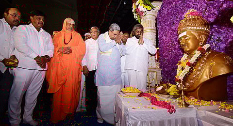 CM offers tributes to Basavanna at Basava Jayanti celebrations in Mysuru. Suttur Seer Sri Shivarathri Deshikendra Swami, and ministers HC Mahadevappa and Eshwar Khandre look on| Udayashankar S