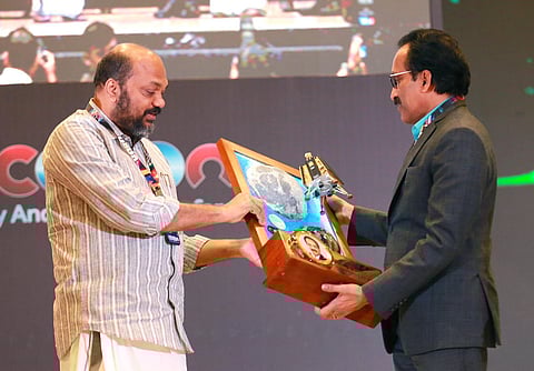 ISRO chairman S Somanath taking a look at the momento presented by Industries Minister P Rajeeve at the cOcOn cyber conference concluding ceremony in Kochi on Saturday. (Photo | T P Sooraj)