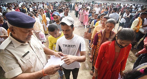 A police official checks documents of aspirants before entering an examination center to appear for the Bihar Constable exam.(File Photo | PTI)