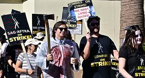 SAG-AFTRA members dress in costume for Halloween as they walk the picket line outside Paramount Studios in Los Angeles.(Photo | AFP)