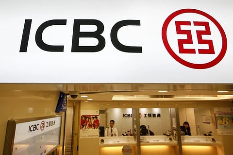 FILE - Bank tellers sit in a branch office of the ICBC in Hong Kong on March 27, 2013. (Photo | AP)