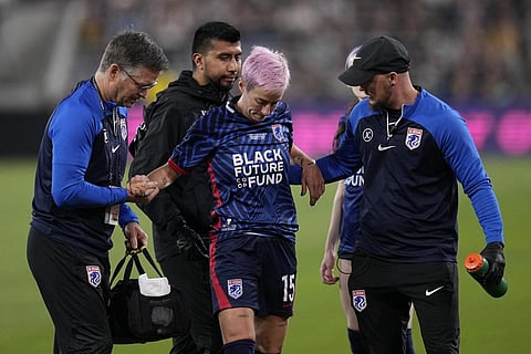 Megan Rapinoe is helped up by team officials after an injury during the first half of the NWSL Championship soccer game against Gotham FC, Saturday, Nov 11, 2023. (Photo | AP)