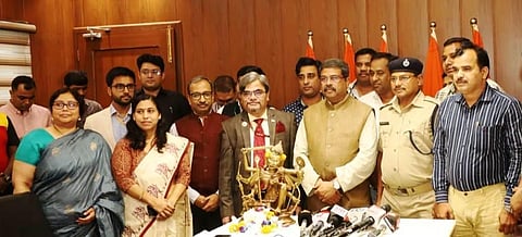 Union Minister Dharmendra Pradhan with the stolen Ashtadhatu idol. (Photo | Express)