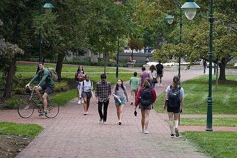 FILE - Students walk to and from classes on the Indiana University campus, Thursday, Oct 14, 2021. (Photo | AP)