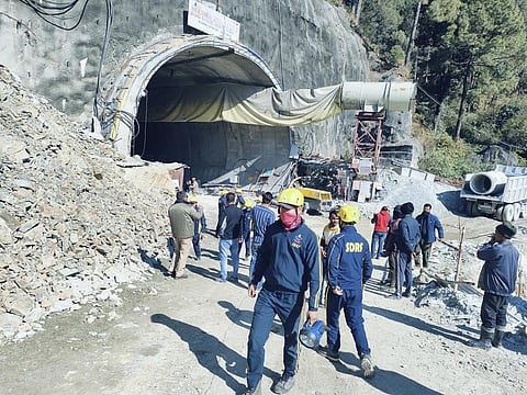 Rescuers outside a collapsed road tunnel where more than 30 workers were trapped by a landslide. (Photo | AP)