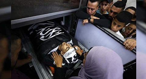 FILE: A family member bids farewell at the hospital morgue to a Palestinian man killed the day before in clashes with the Israeli military in the Jenin refugee camp | AFP