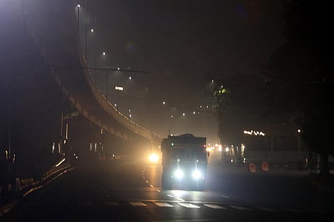 Vehicles pass through a smoke-filled road in Hyderabad on Monday. People burst crackers in a street in the city during Diwali celebrations on Sunday night. (Photo | Sri Loganathan Velmurugan)