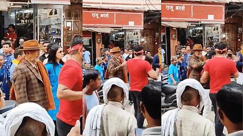 Patekar is seen dressed in a suit and wearing a hat, getting ready to shoot a scene when the fan comes close to him and tries to click a selfie. (Videograbs)