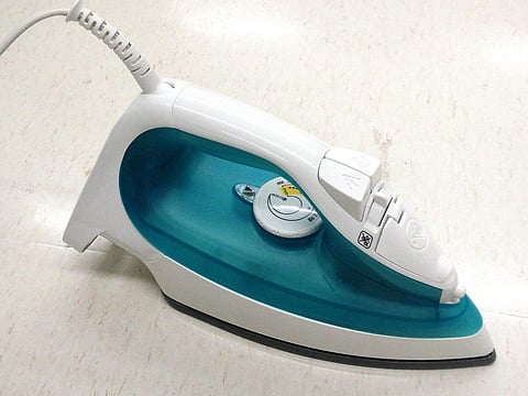 Image of an electric iron used for representational purposes.