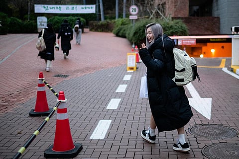 South Korean singer and actress Kang Ye-seo, known as Yeseo, arrives to sit for the annual college entrance exam, known locally as Suneung, in Seoul on Nov 16, 2023. (AFP)