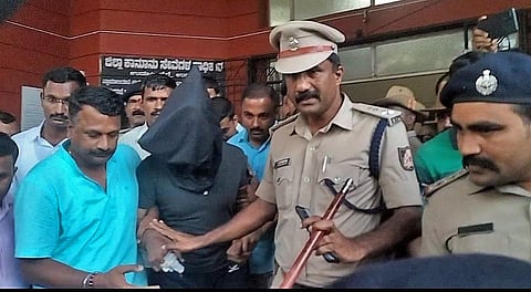Police take accused Praveen Arun Chougule away, after his appearance in court, in Udupi on Wednesday | Express