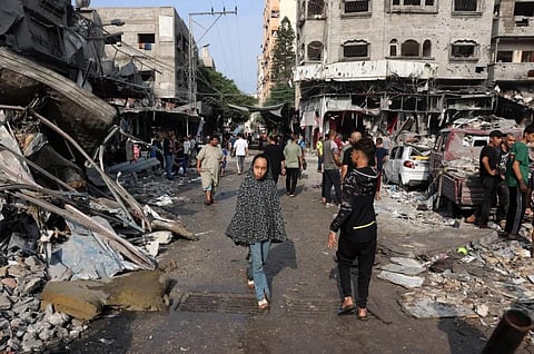 A young girl walks amid the destruction following Israeli attacks on al-Shatee camp in Gaza City on Saturday. (Photo | AFP)