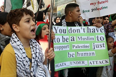 FILE - Palestinian children hold signs during a protest in support of Gaza, in the Ain al-Hilweh refugee camp, near southern Lebanese port city of Sidon on October 18, 2023. (Photo | AFP)