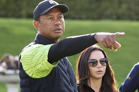 FILE - Tiger Woods, left, and Erica Herman appear on the 18th green during the JP McManus Pro-Am at Adare Manor, Limerick, Ireland, July, 4, 2022. (Photo | AP)