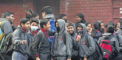 Students wearing face masks assemble outside a school even as air quality worsened to severe category on Thursday, Oct 16, 2023. (Photo | PTI)