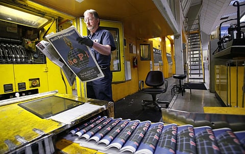 Pressman Jim Herron looks over a final edition of the Seattle Post- Intelligencer as it comes off the press on March 16, 2009. (Photo | AP)