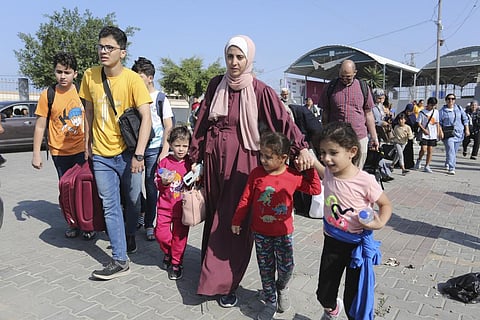 Palestinians cross to the Egyptian side of the border crossing with the Gaza Strip in Rafah Wednesday, Nov. 1, 2023. (Photo | AP)