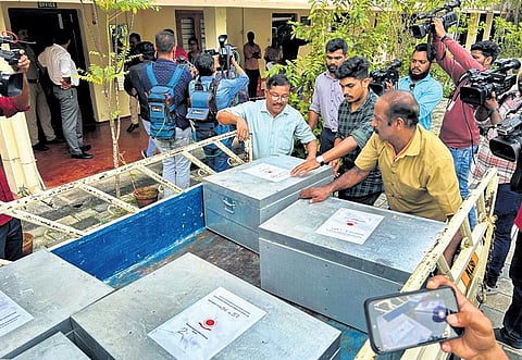 ED officials offloading the prosecution complaint from a goods carrier in front of the PMLA court in Kochi on Wednesday | Express