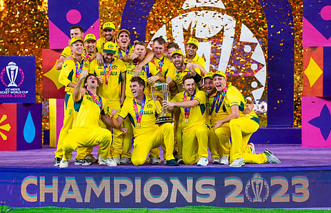 Australian players celebrate with the trophy after winning the ICC Mens Cricket World Cup 2023 finals at the Narendra Modi Stadium, in Ahmedabad, Sunday, Nov. 19, 2023. (Photo | PTI)