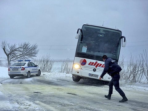Policeman walks in front of a bus gone off the road near the town of Dobrich, Bulgaria, Sunday, Nov 19, 2023. (Photo | AP)