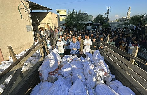 Palestinians pray over the bodies of people killed by Israeli airstrikes on Jabaliya refugee camp, at the Indonesian hospital, northern Gaza Strip, Saturday, Nov. 18, 2023. (AP)