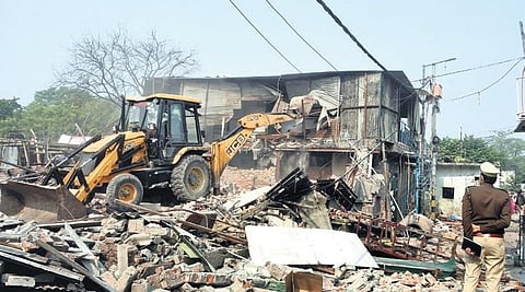 Demolition drive being conducted against alleged illegal constructions in a slum cluster near Sunder Nursery on Wednesday | Parveen Negi