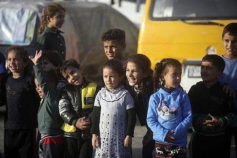 Displaced Palestinian children sheltering at a UN school, attend an entertainment performance in Rafah refugee camp, Nov 23. 2023. (Photo | AP)