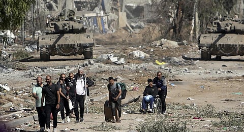 Palestinians flee to northern Gaza as Israeli tanks block the Salah al-Din road in the central Gaza Strip on Friday, Nov. 24, 2023.(Photo | AP)