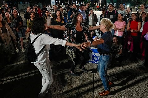 People react as they hear the news of the release of 13 Israeli hostages held by Hamas in the Gaza strip, in Tel Aviv, Israel, on Friday, November 24, 2023. (Photo | AP)